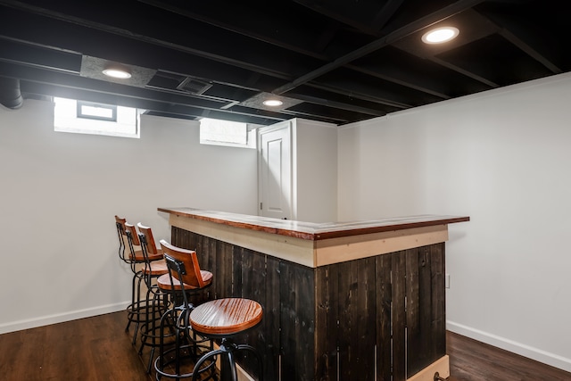 bar featuring dark hardwood / wood-style flooring