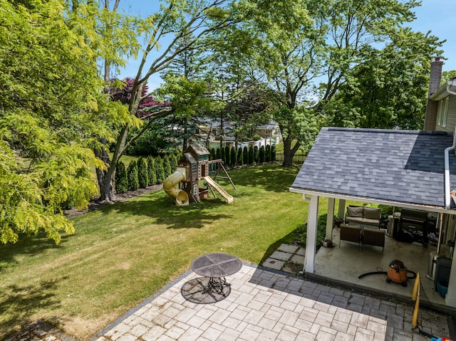 view of yard with a playground and a patio