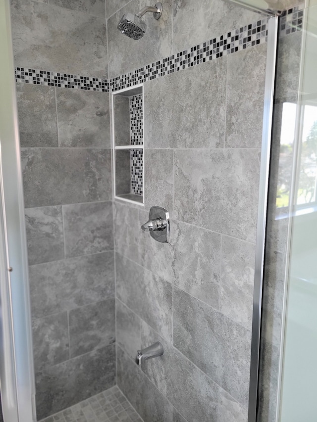 bathroom with a tile shower