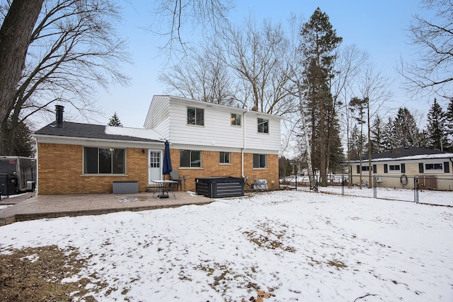 snow covered rear of property with central AC unit