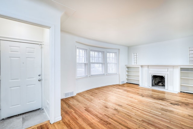 unfurnished living room with light wood-type flooring