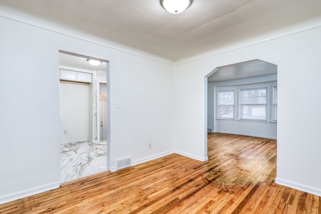 spare room with light wood-type flooring