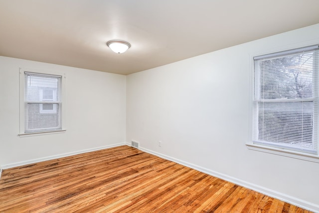 unfurnished room with hardwood / wood-style flooring