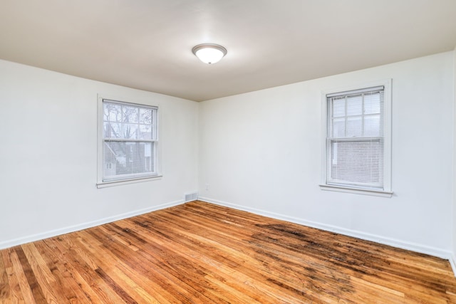 spare room with hardwood / wood-style flooring