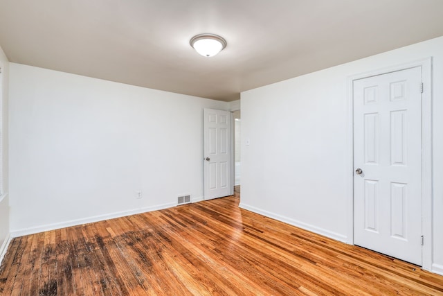 spare room featuring wood-type flooring