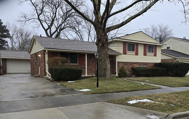 split level home with a garage and a front lawn