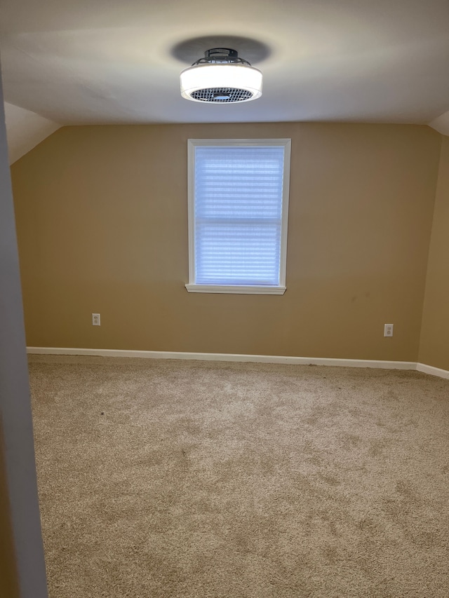 bonus room featuring lofted ceiling and carpet floors