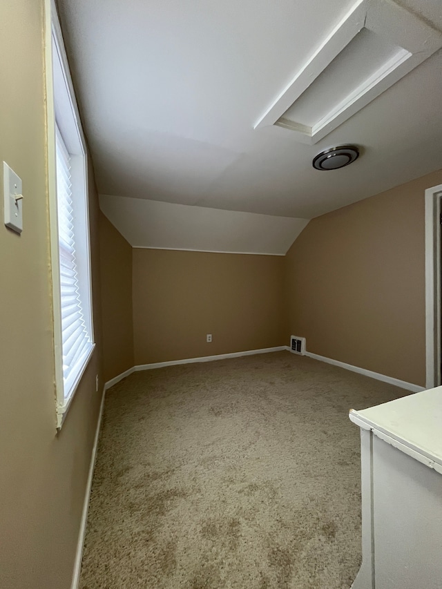 bonus room featuring lofted ceiling and carpet flooring