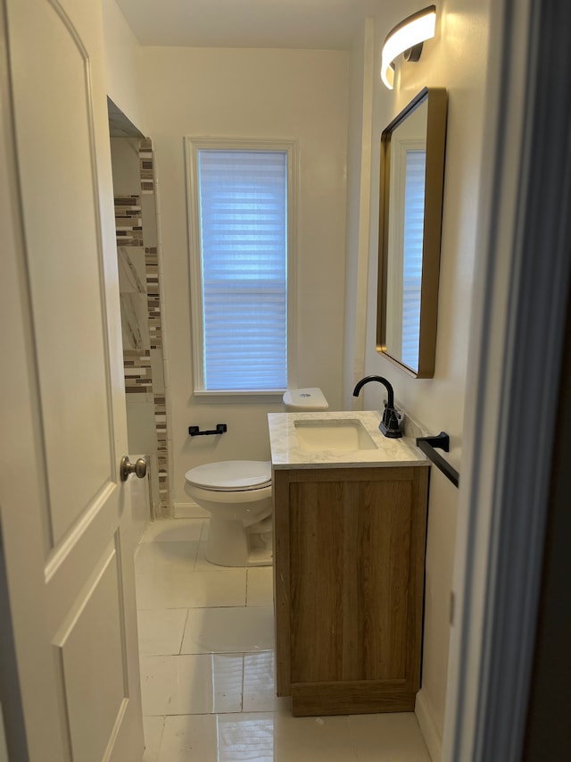 bathroom with vanity, tile patterned floors, and toilet