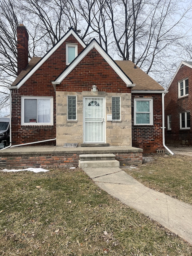 bungalow-style home with a front lawn