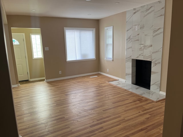 unfurnished living room featuring a fireplace and light wood-type flooring