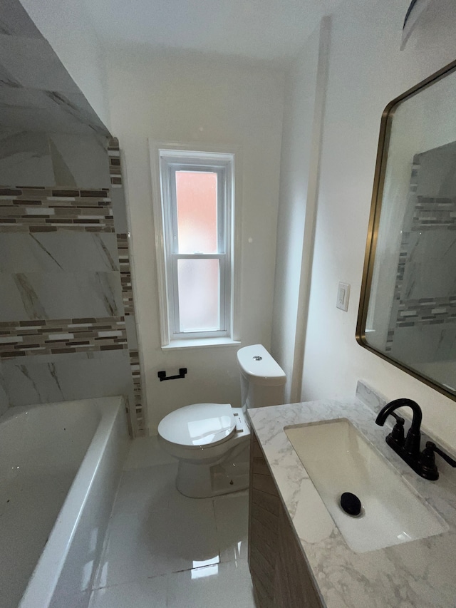 bathroom featuring toilet, vanity, and a tub to relax in