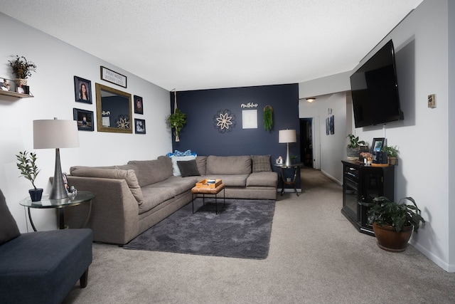 carpeted living area featuring a textured ceiling and baseboards