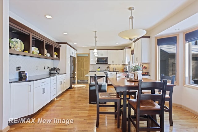 dining area featuring light wood-type flooring