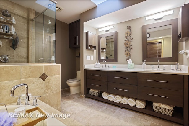 bathroom with vanity, a shower with door, and toilet