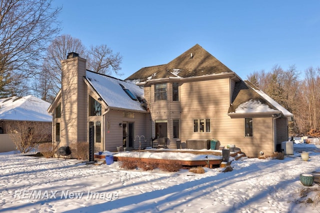 view of snow covered rear of property