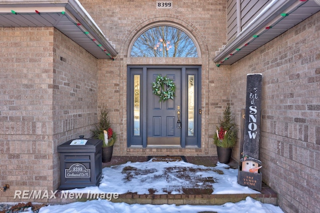 view of snow covered property entrance