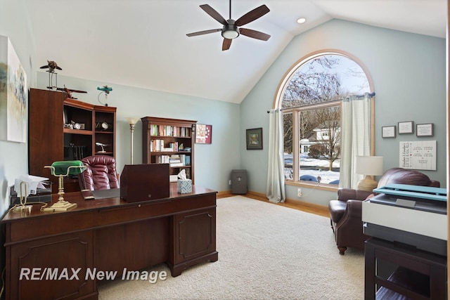 home office with light carpet, high vaulted ceiling, and ceiling fan