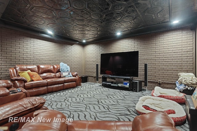 carpeted living room featuring brick wall