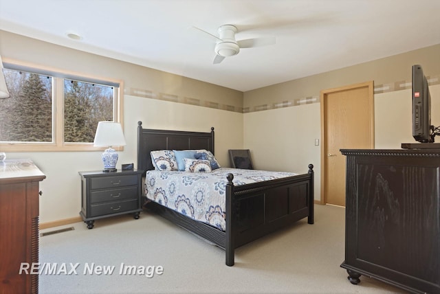 bedroom featuring ceiling fan and light carpet