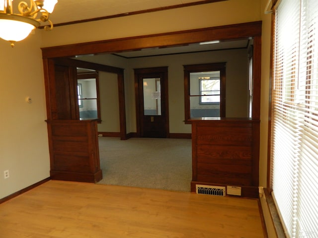 hallway featuring wood-type flooring and a chandelier