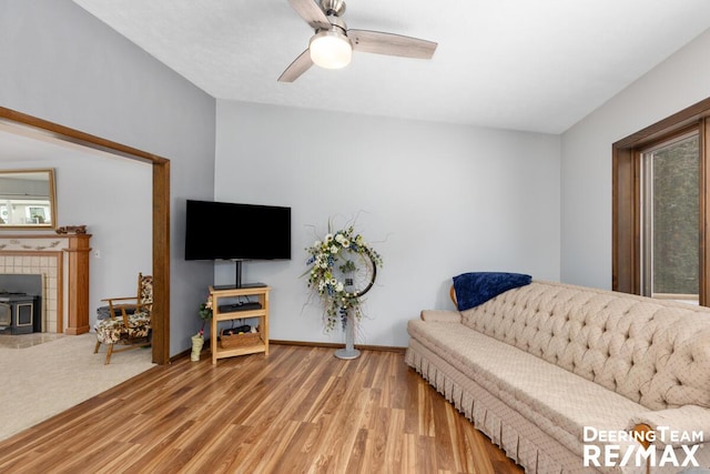 living room with hardwood / wood-style flooring and ceiling fan