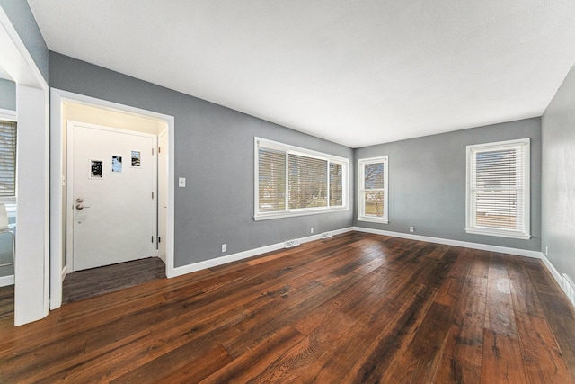 entryway featuring dark wood-type flooring and a healthy amount of sunlight