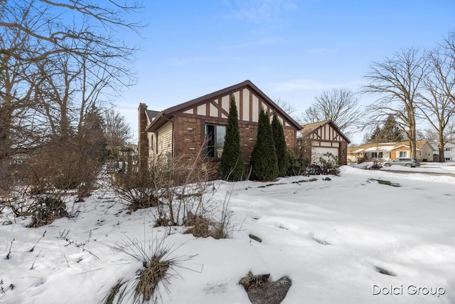 snow covered property featuring a garage