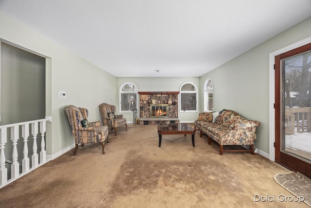 carpeted living room with a fireplace and a textured ceiling