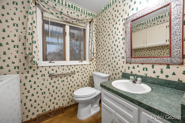 bathroom featuring vanity and toilet