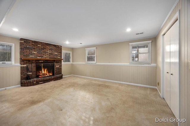 unfurnished living room featuring light colored carpet and a fireplace