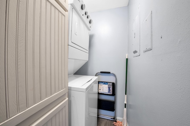 washroom featuring stacked washer / dryer