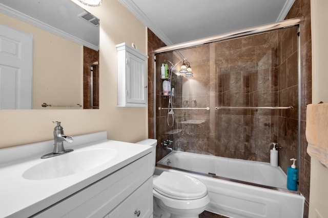 full bathroom with ornamental molding, vanity, shower / bath combination with glass door, and toilet