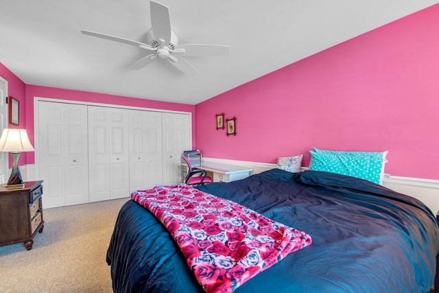 bedroom featuring light colored carpet, a closet, and ceiling fan