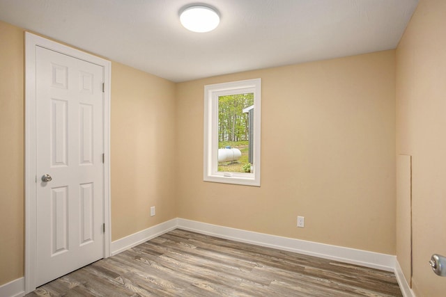 unfurnished room with wood-type flooring