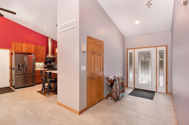 foyer featuring high vaulted ceiling