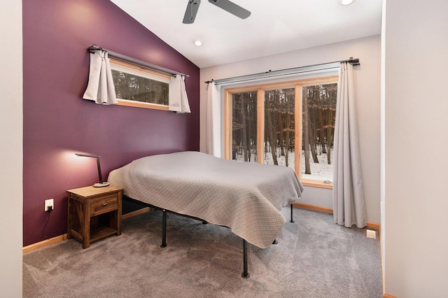 bedroom featuring ceiling fan, lofted ceiling, and light carpet