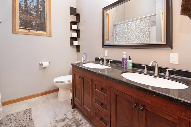 bathroom featuring tile patterned flooring, vanity, and toilet