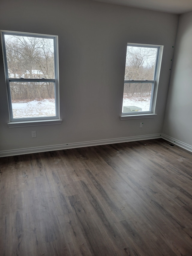 empty room featuring dark hardwood / wood-style flooring