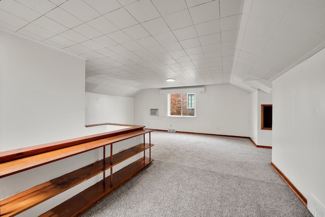 bonus room featuring vaulted ceiling and light carpet