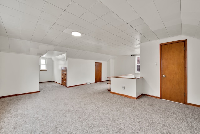 bonus room featuring light carpet and lofted ceiling