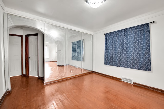 unfurnished room with hardwood / wood-style flooring