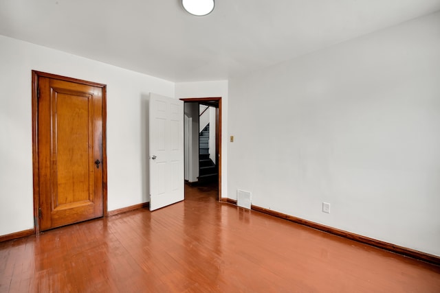 unfurnished bedroom featuring hardwood / wood-style flooring