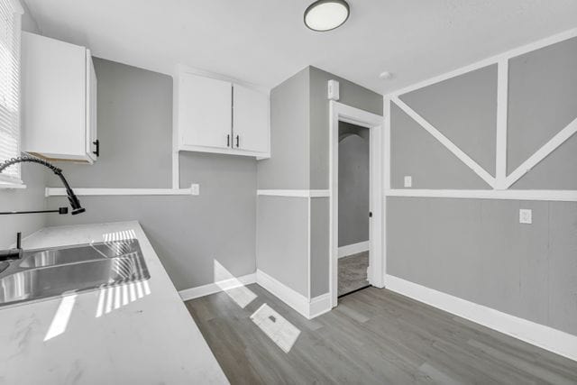 kitchen featuring white cabinetry, sink, and dark wood-type flooring