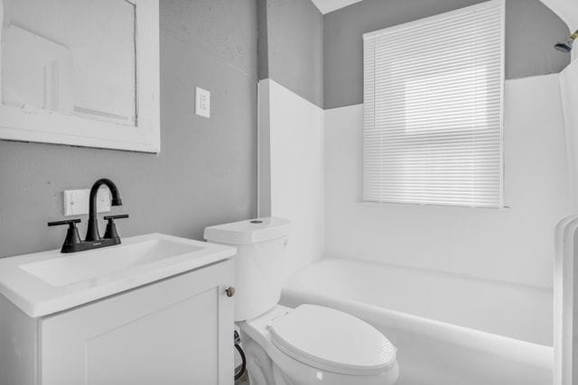 full bathroom with vanity, shower / washtub combination, and toilet