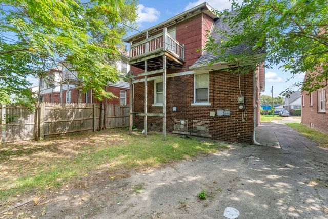 back of house featuring a balcony