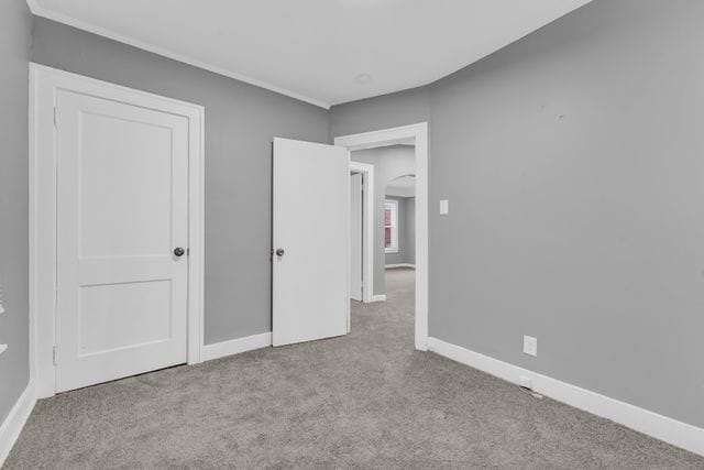 unfurnished bedroom featuring light carpet