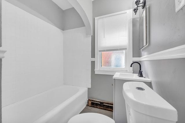 full bathroom featuring vanity,  shower combination, and toilet