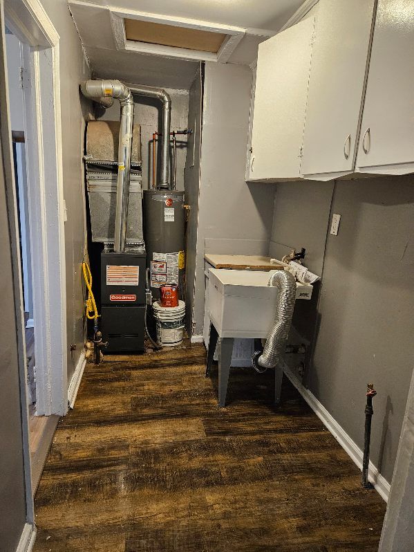 utility room with sink and gas water heater