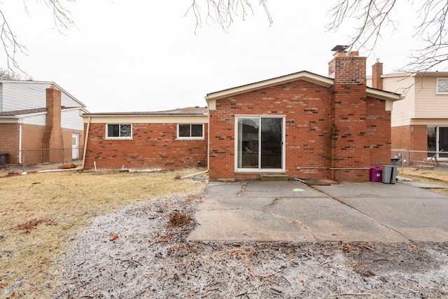 back of house with a yard and a patio area